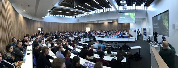 A full lecture theatre watching a talk at DrupalCamp London 2017.