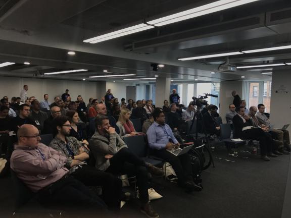 An audience listening to a talk in a seminar room at DrupalCamp London 2017.