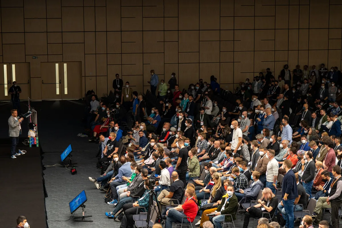 A crowded hall listening to a keynote at DrupalCon Prague 2022