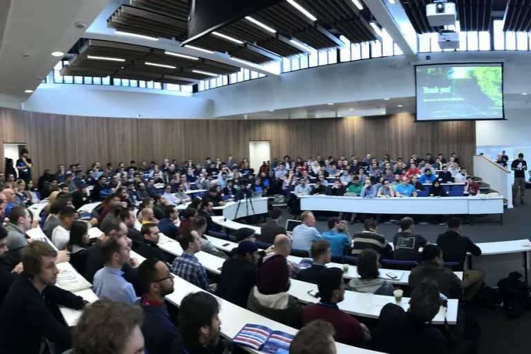 A full lecture theatre watching a talk at DrupalCamp London 2017.