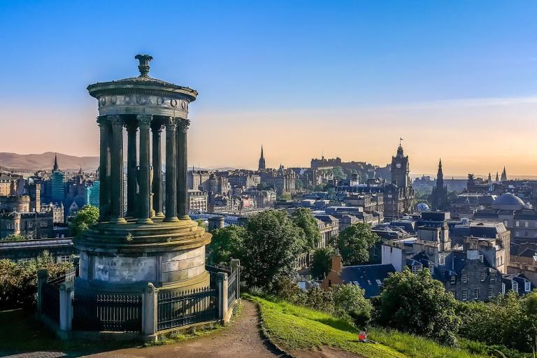 The Edinburgh skyline from Calton Hill, with the Dugald Stewart Monument in the foreground and the castle in the distance.